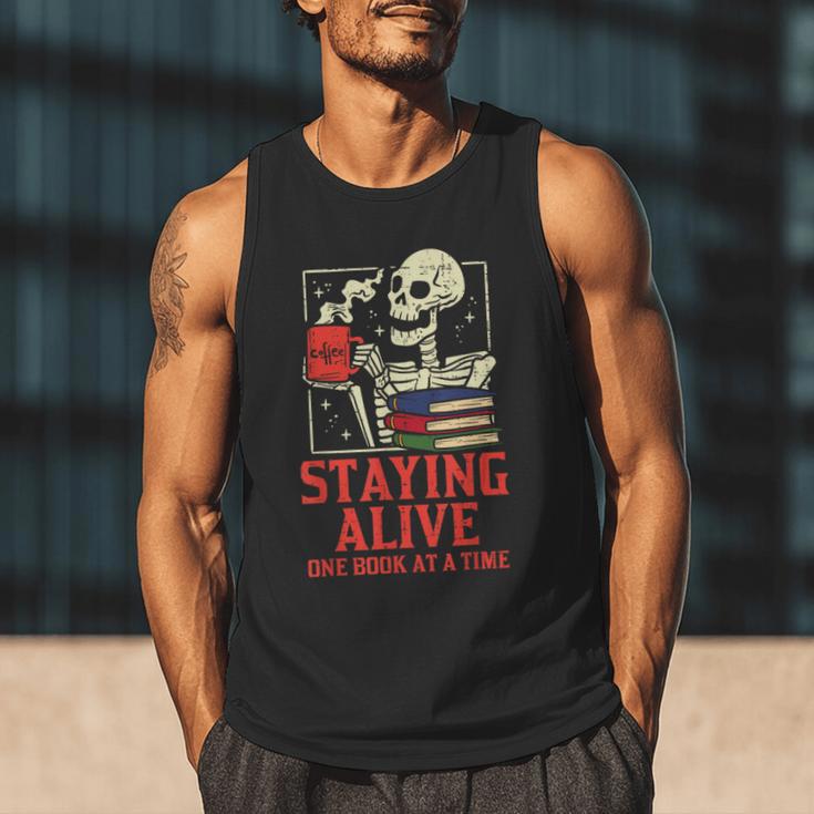 Staying Alive One Book At A Time Skeleton Reading Librarian Men Tank Top Staying Alive One Book At A Time Skeleton Reading Librarian Men Tank Top