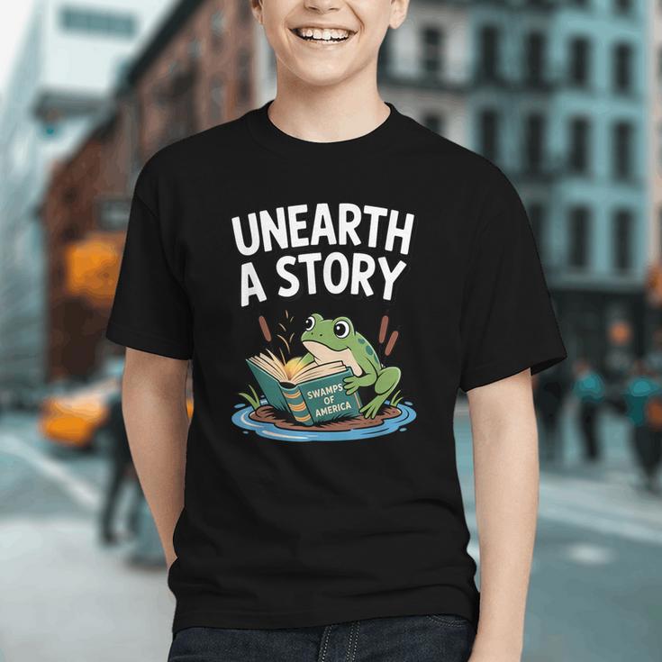 Unearth a Story Frog Reading a Book Summer 2026 Graphic Youth