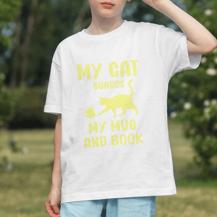 My Cat Guards My Mug And Book Humor Cats Premium Tri-Blend Graphic Youth My Cat Guards My Mug And Book Humor Cats Premium Tri-Blend Graphic Youth