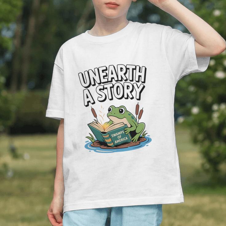 Unearth a Story Frog Reading a Book Summer 2026 Premium Tri-Blend Graphic Youth Unearth a Story Frog Reading a Book Summer 2026 Premium Tri-Blend Graphic Youth