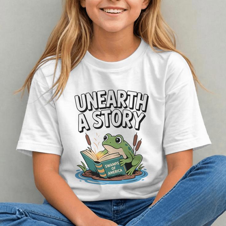 Unearth a Story Frog Reading a Book Summer 2026 Premium Tri-Blend Graphic Youth Unearth a Story Frog Reading a Book Summer 2026 Premium Tri-Blend Graphic Youth