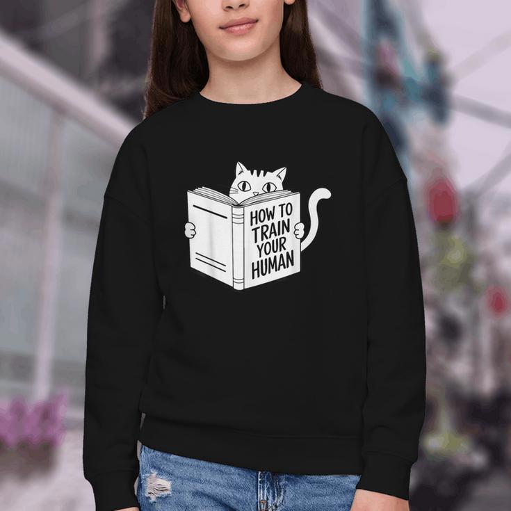 Cat Book Humor How To Train Your Human Youth Crewneck Sweatshirt Cat Book Humor How To Train Your Human Youth Crewneck Sweatshirt