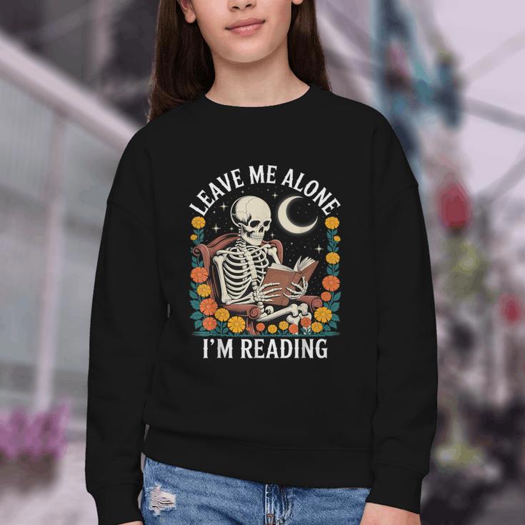 Leave Me Alone Skeleton Reading Book Floral Moon Librarian Youth Crewneck Sweatshirt