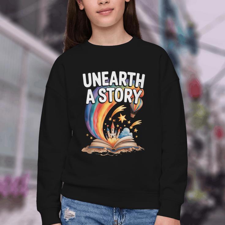 Unearth A Story Rainbow Treasure Book Youth Crewneck Sweatshirt Unearth A Story Rainbow Treasure Book Youth Crewneck Sweatshirt