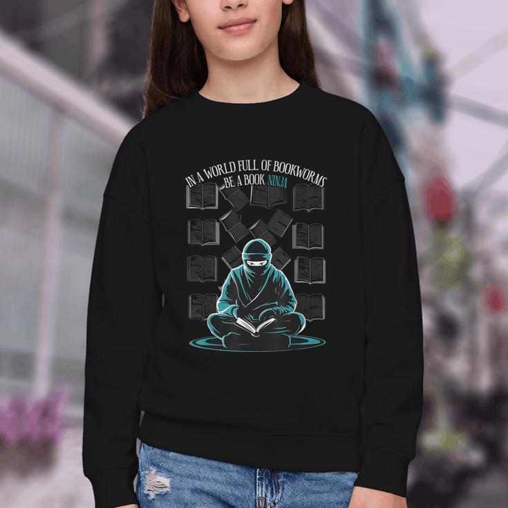 In A World Full Of Bookworms Be A Book Ninja Reading Reader Youth Crewneck Sweatshirt In A World Full Of Bookworms Be A Book Ninja Reading Reader Youth Crewneck Sweatshirt