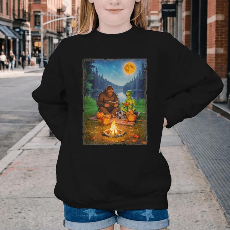 Bigfoot And Alien Reading Books Campfire Halloween Youth Crewneck Sweatshirt