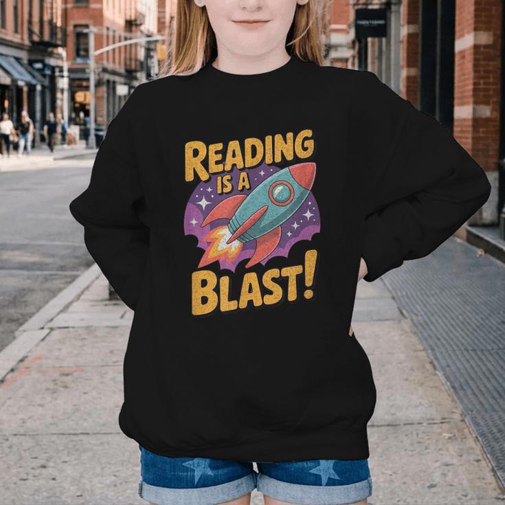 Book Lover Kids And Adults Reading Is a Blast Rocket Ship Youth Crewneck Sweatshirt
