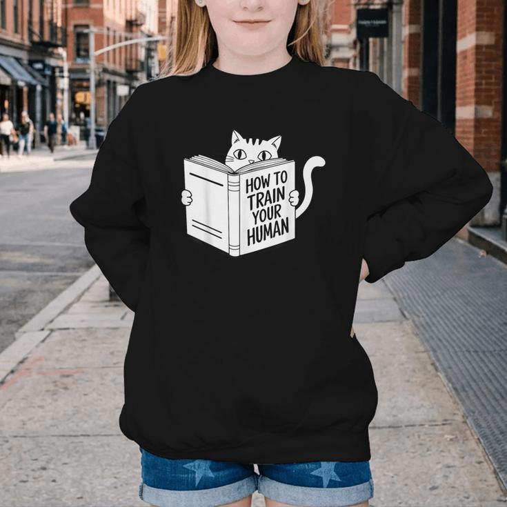 Cat Book Humor How To Train Your Human Youth Crewneck Sweatshirt Cat Book Humor How To Train Your Human Youth Crewneck Sweatshirt