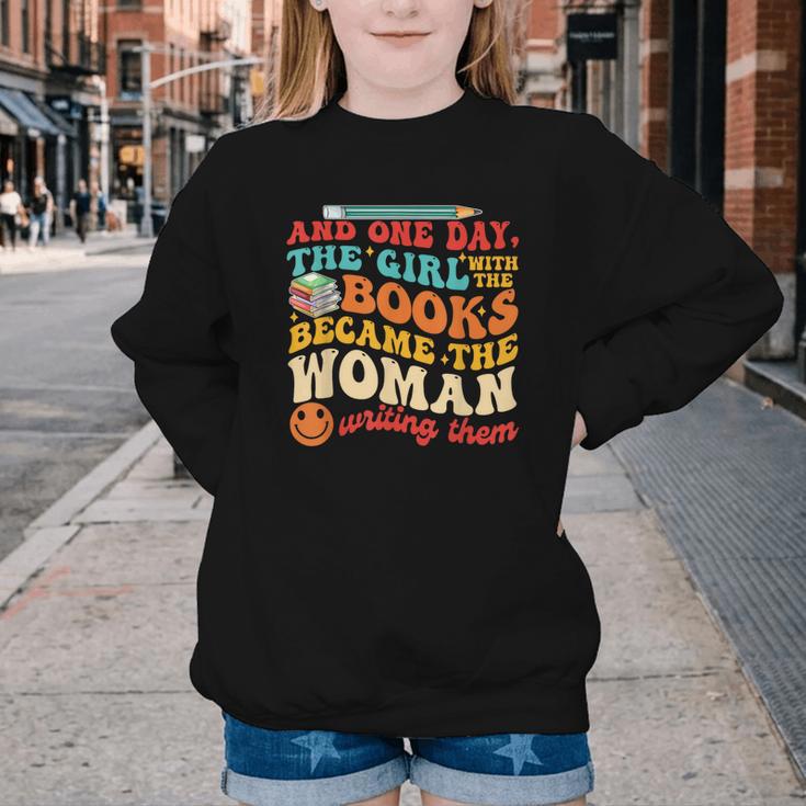 The Girl With The Books Became The Woman Writing Them Youth Crewneck Sweatshirt The Girl With The Books Became The Woman Writing Them Youth Crewneck Sweatshirt