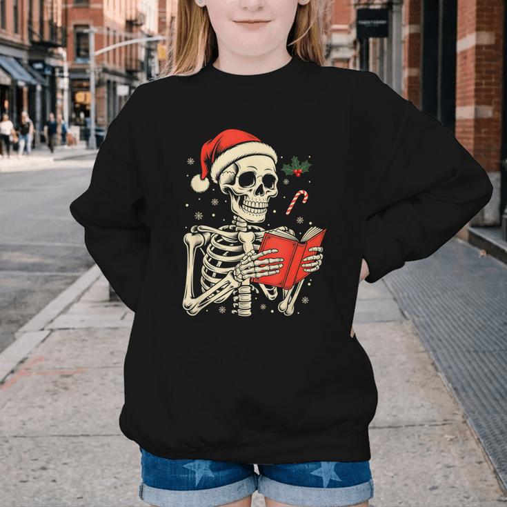 Skeleton Reading Book Christmas Teacher Librarian Book Lover Youth Crewneck Sweatshirt Skeleton Reading Book Christmas Teacher Librarian Book Lover Youth Crewneck Sweatshirt