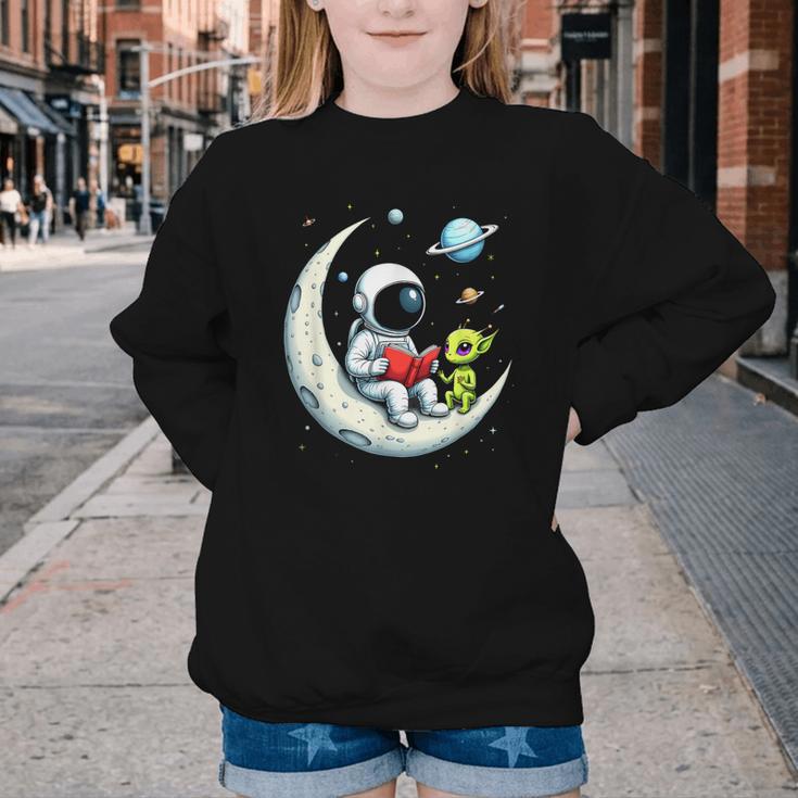 UFO Alien Astronaut Reading Book In Space Youth Crewneck Sweatshirt