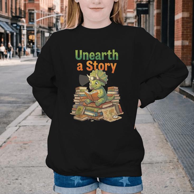 Unearth a Story Triceratops Dinosaur Reading Books Cute Dino Youth Crewneck Sweatshirt Unearth a Story Triceratops Dinosaur Reading Books Cute Dino Youth Crewneck Sweatshirt