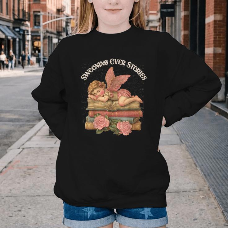 Valentine's Swooning Over Stories Cupid And Book Lover Tee Youth Crewneck Sweatshirt
