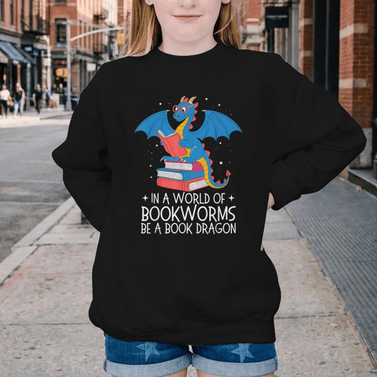 In A World Full Of Bookworms Be A Book Dragon Reading Youth Crewneck Sweatshirt