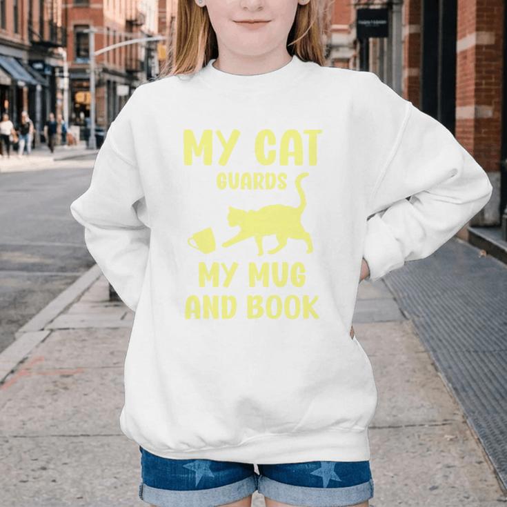 My Cat Guards My Mug And Book Humor Cats Premium Tri-Blend Youth Crewneck Sweatshirt My Cat Guards My Mug And Book Humor Cats Premium Tri-Blend Youth Crewneck Sweatshirt