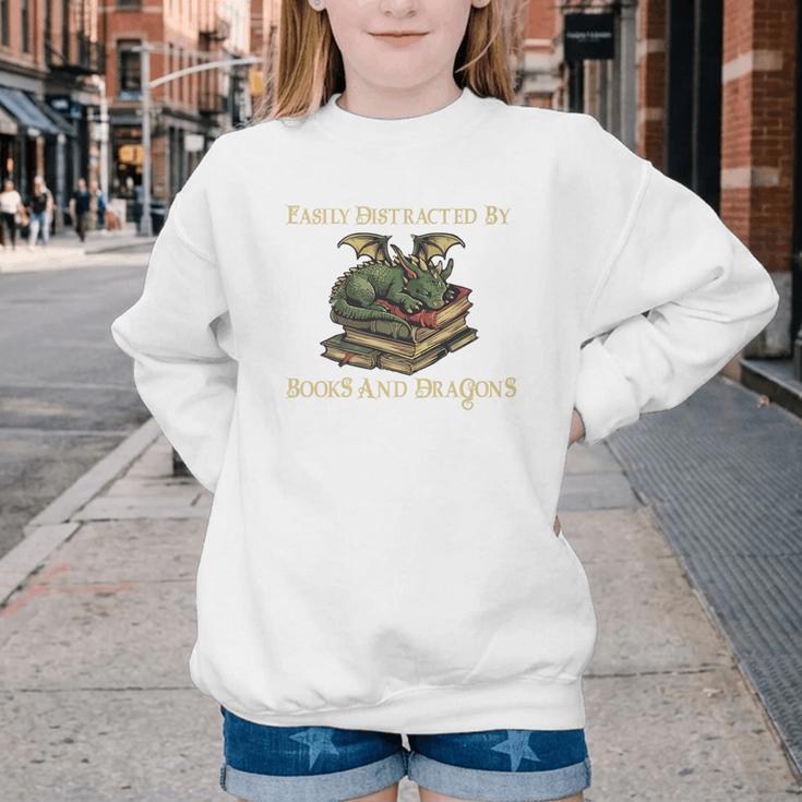 Easily Distracted By Books And Dragons Graphic Premium Youth Crewneck Sweatshirt Easily Distracted By Books And Dragons Graphic Premium Youth Crewneck Sweatshirt