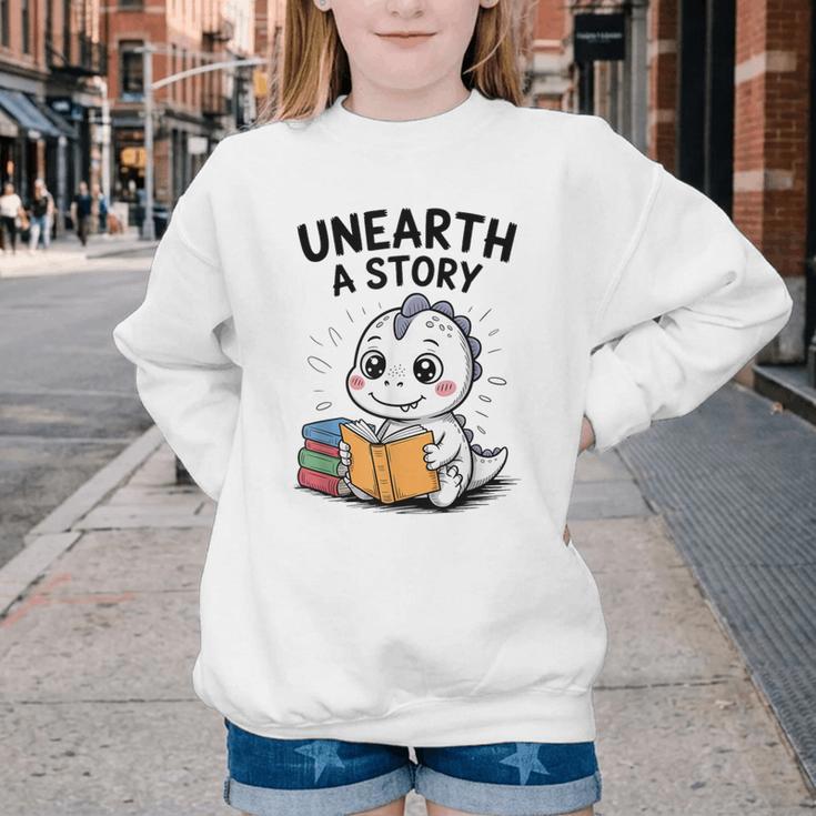 Unearth a Story Cute Dinosaur Summer Reading 2026 Dino Book Youth Crewneck Sweatshirt Unearth a Story Cute Dinosaur Summer Reading 2026 Dino Book Youth Crewneck Sweatshirt