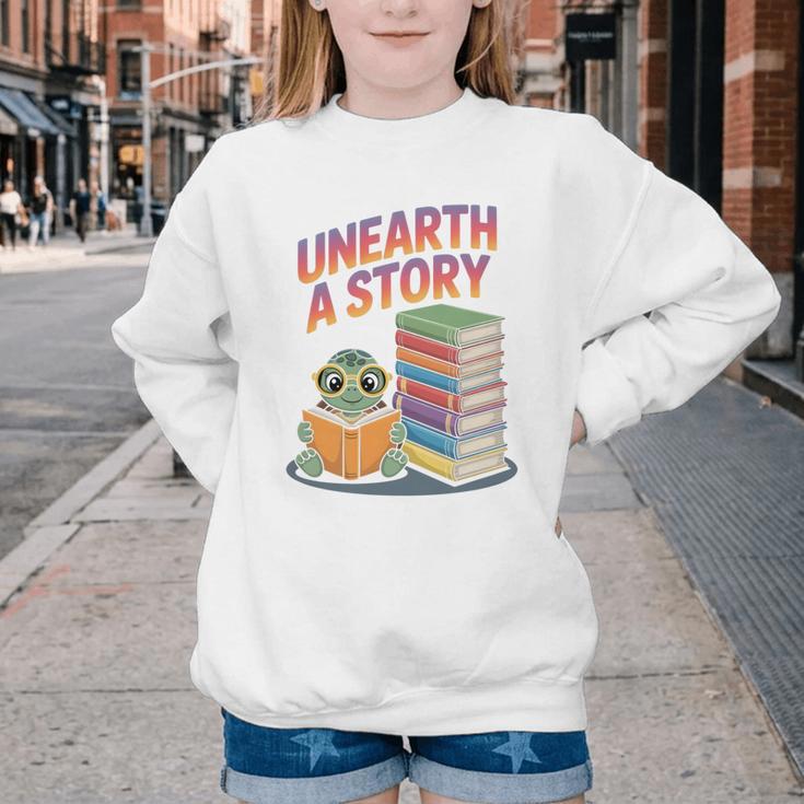 Unearth A Story Cute Turtle Reading Books Librarian Youth Crewneck Sweatshirt