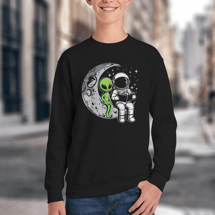Astronaut Reading Book To Alien Moon Space Women Kids Men Youth Crewneck Sweatshirt