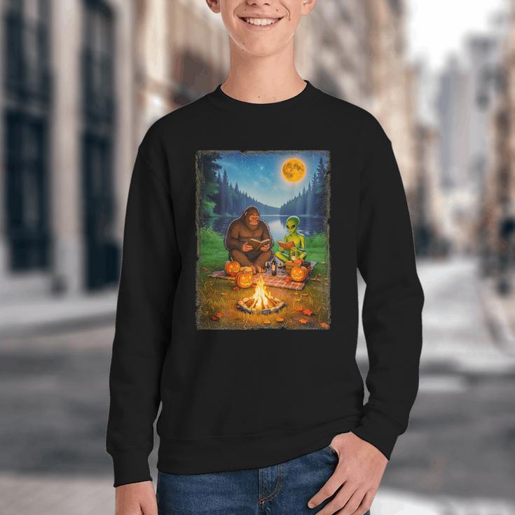 Bigfoot And Alien Reading Books Campfire Halloween Youth Crewneck Sweatshirt