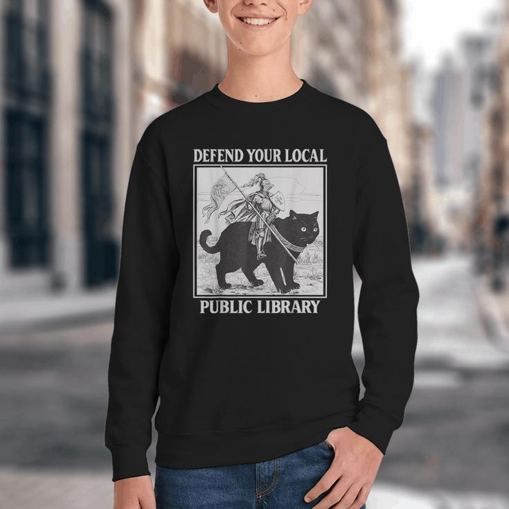 Defend Your Local Library Knight Cat Rider Book Lover Youth Crewneck Sweatshirt Defend Your Local Library Knight Cat Rider Book Lover Youth Crewneck Sweatshirt