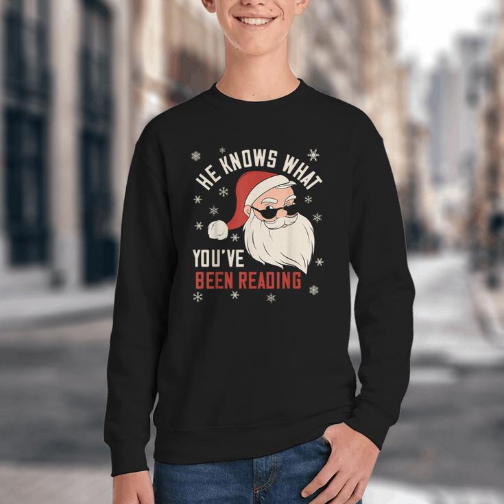 He Knows What You'Ve Been Reading Book Lover Women Santa Youth Crewneck Sweatshirt