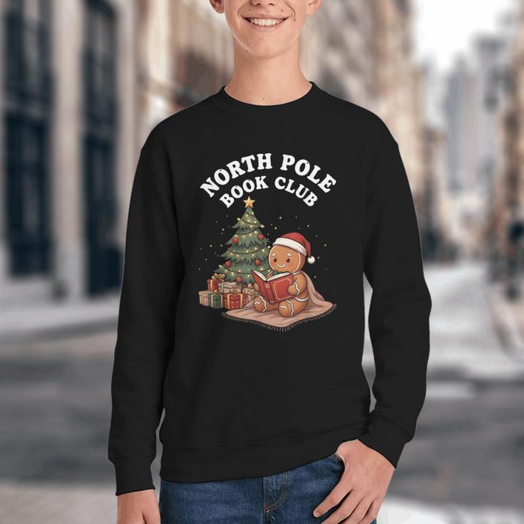 North Pole Book Club Gingerbread Christmas Reading Youth Crewneck Sweatshirt North Pole Book Club Gingerbread Christmas Reading Youth Crewneck Sweatshirt