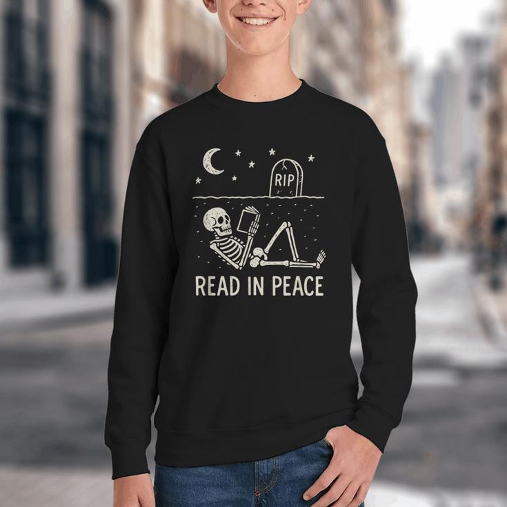 Skeleton Read In Peace Halloween Book Graphic Bookish Youth Crewneck Sweatshirt Skeleton Read In Peace Halloween Book Graphic Bookish Youth Crewneck Sweatshirt