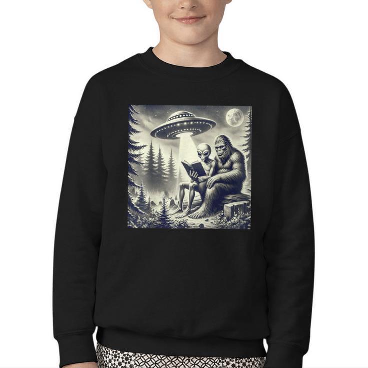 Bigfoot With Alien Reading A Book Bigfoot And UFO Youth Crewneck Sweatshirt