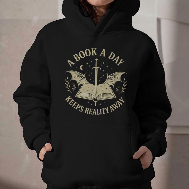 A Book A Day Keeps Reality Away Reading Escape Quote Graphic Youth Hoodie A Book A Day Keeps Reality Away Reading Escape Quote Graphic Youth Hoodie