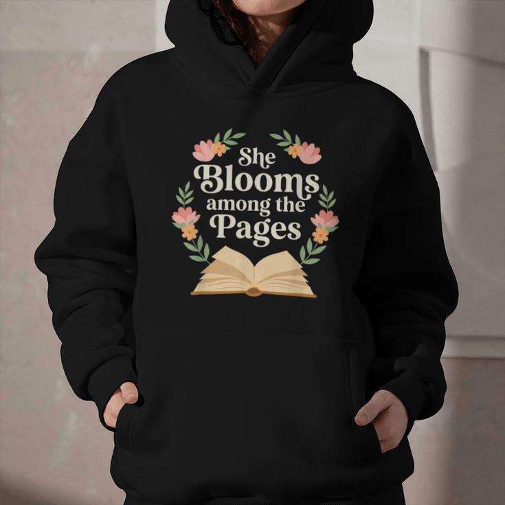 She Blooms Among The Pages Women Mom Wife Floral Book Quote Graphic Youth Hoodie She Blooms Among The Pages Women Mom Wife Floral Book Quote Graphic Youth Hoodie