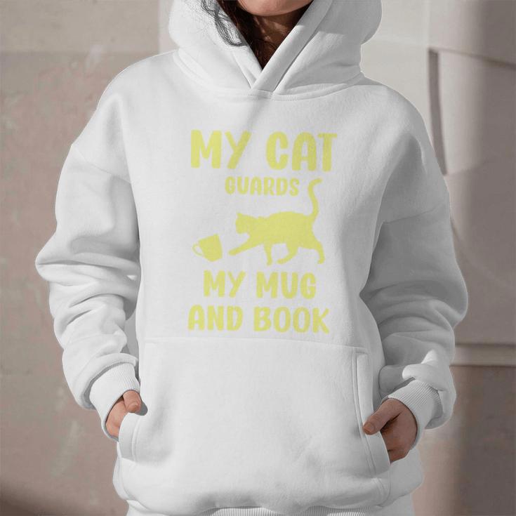 My Cat Guards My Mug And Book Humor Cats Premium Tri-Blend Graphic Youth Hoodie My Cat Guards My Mug And Book Humor Cats Premium Tri-Blend Graphic Youth Hoodie