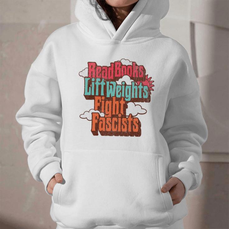 Read Books Lift Weights Fight Fascists Reading No Kings Premium Tri-Blend Graphic Youth Hoodie Read Books Lift Weights Fight Fascists Reading No Kings Premium Tri-Blend Graphic Youth Hoodie
