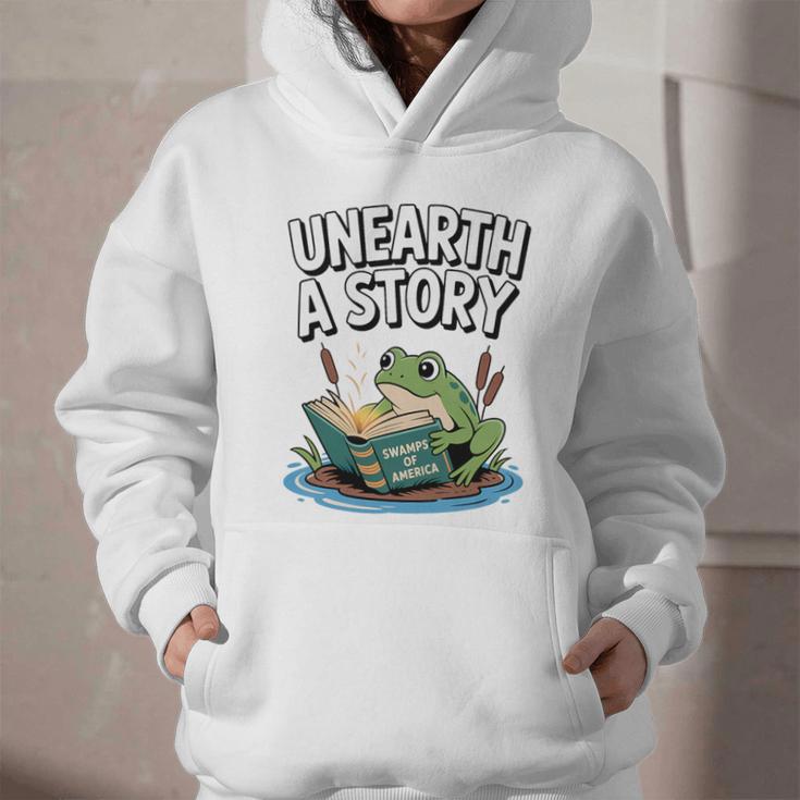 Unearth a Story Frog Reading a Book Summer 2026 Premium Tri-Blend Graphic Youth Hoodie Unearth a Story Frog Reading a Book Summer 2026 Premium Tri-Blend Graphic Youth Hoodie