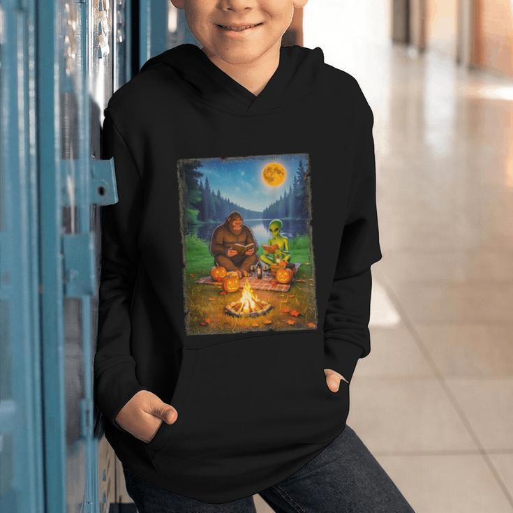Bigfoot And Alien Reading Books Campfire Halloween Graphic Youth Hoodie Bigfoot And Alien Reading Books Campfire Halloween Graphic Youth Hoodie