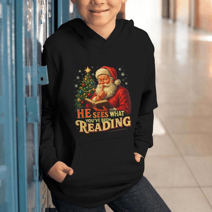 He Sees What You’Ve Been Reading Santa Book Lover Christmas Graphic Youth Hoodie He Sees What You’Ve Been Reading Santa Book Lover Christmas Graphic Youth Hoodie