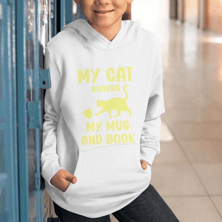 My Cat Guards My Mug And Book Humor Cats Premium Tri-Blend Graphic Youth Hoodie My Cat Guards My Mug And Book Humor Cats Premium Tri-Blend Graphic Youth Hoodie