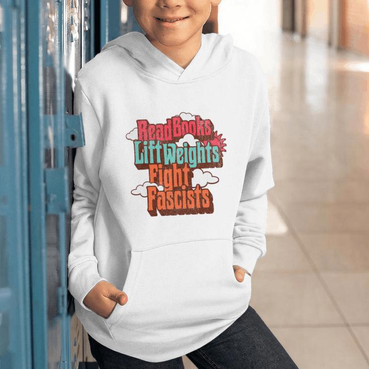 Read Books Lift Weights Fight Fascists Reading No Kings Premium Tri-Blend Graphic Youth Hoodie Read Books Lift Weights Fight Fascists Reading No Kings Premium Tri-Blend Graphic Youth Hoodie