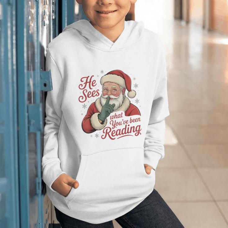 He Sees What You'Ve Been Reading Bookish Christmas Humor Graphic Youth Hoodie He Sees What You'Ve Been Reading Bookish Christmas Humor Graphic Youth Hoodie