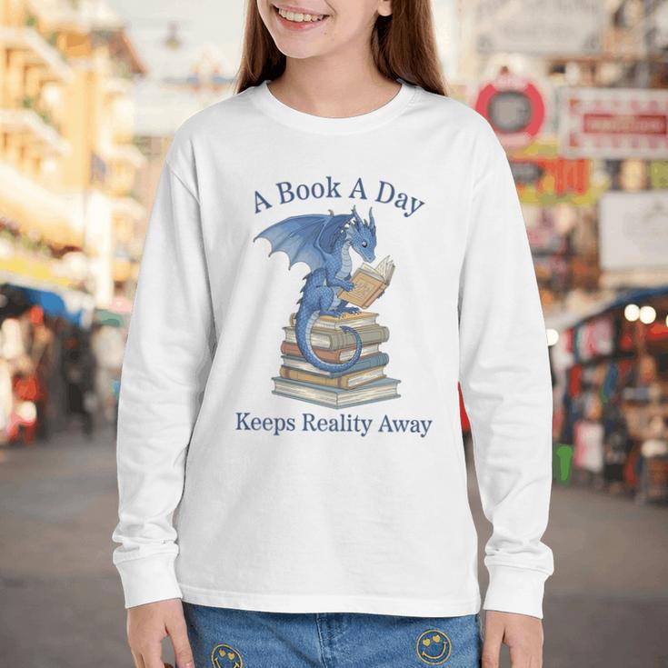 A Book A Day Keeps Reality Away Premium Tri-Blend Youth Long Sleeve Tee A Book A Day Keeps Reality Away Premium Tri-Blend Youth Long Sleeve Tee