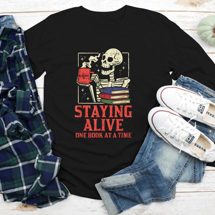 Staying Alive One Book At A Time Skeleton Reading Librarian Youth Long Sleeve Tee