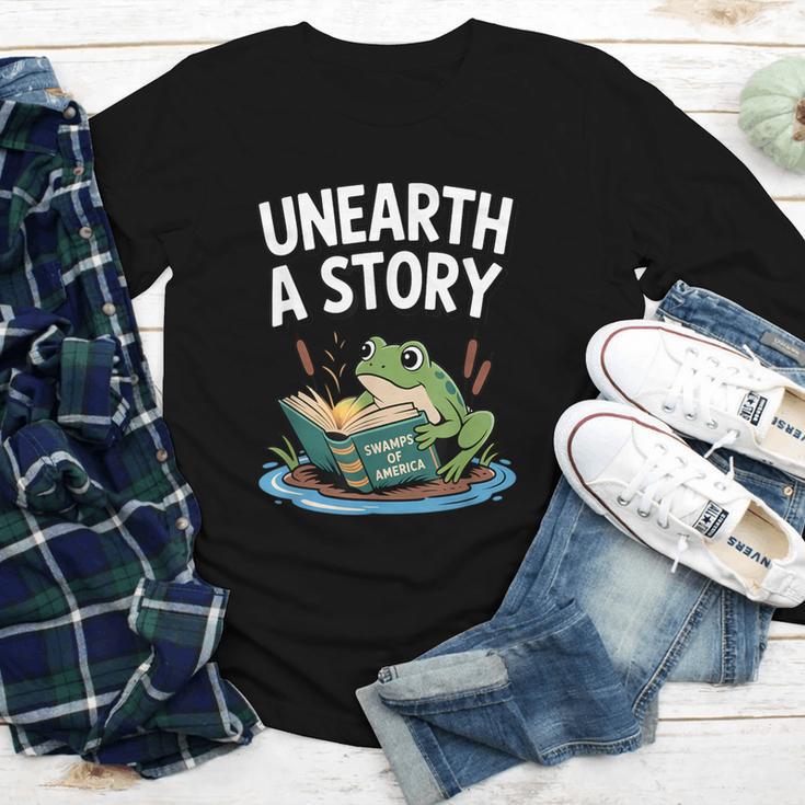 Unearth a Story Frog Reading a Book Summer 2026 Youth Long Sleeve Tee Unearth a Story Frog Reading a Book Summer 2026 Youth Long Sleeve Tee