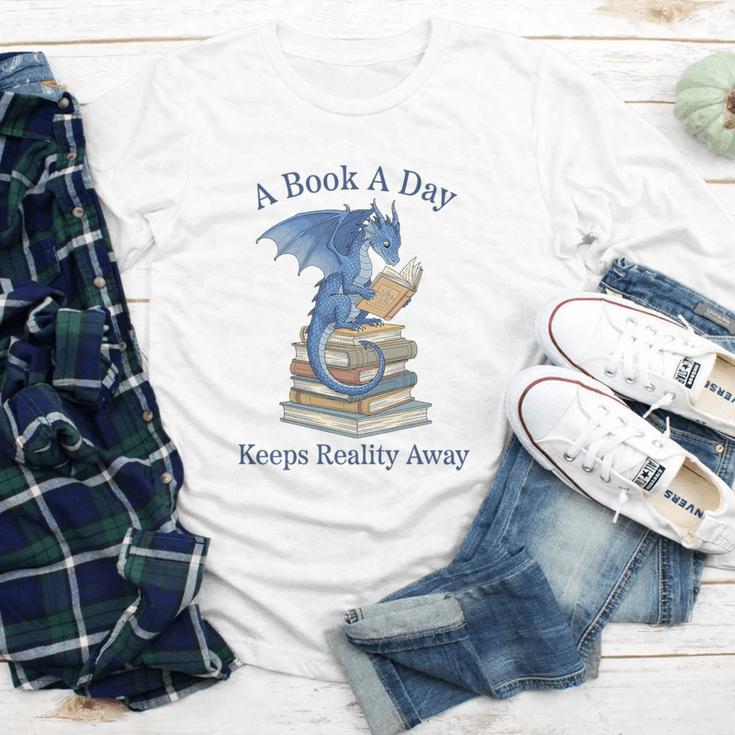 A Book A Day Keeps Reality Away Premium Tri-Blend Youth Long Sleeve Tee A Book A Day Keeps Reality Away Premium Tri-Blend Youth Long Sleeve Tee