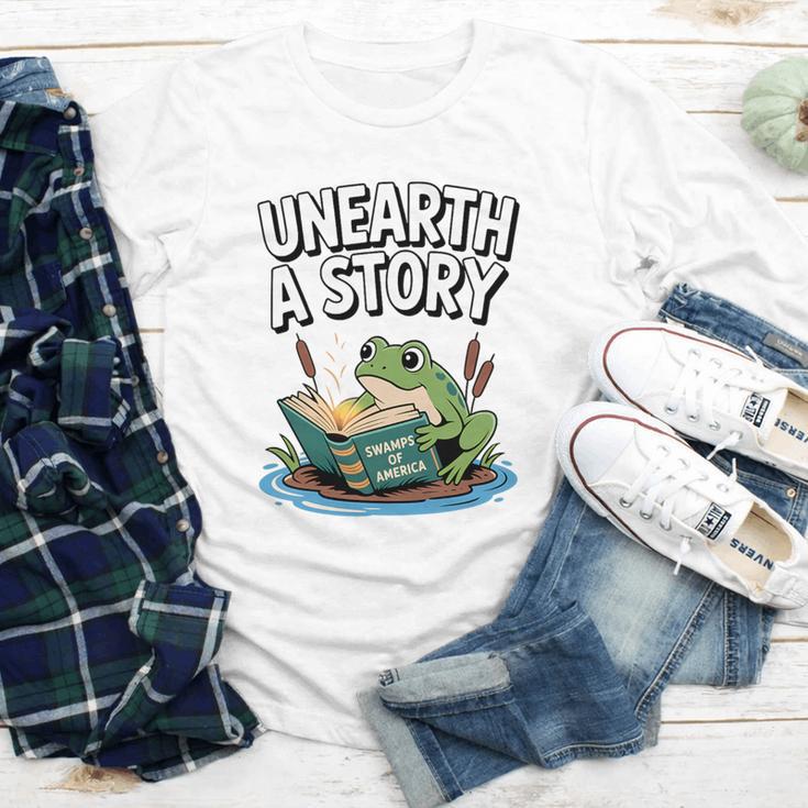 Unearth a Story Frog Reading a Book Summer 2026 Premium Tri-Blend Youth Long Sleeve Tee Unearth a Story Frog Reading a Book Summer 2026 Premium Tri-Blend Youth Long Sleeve Tee
