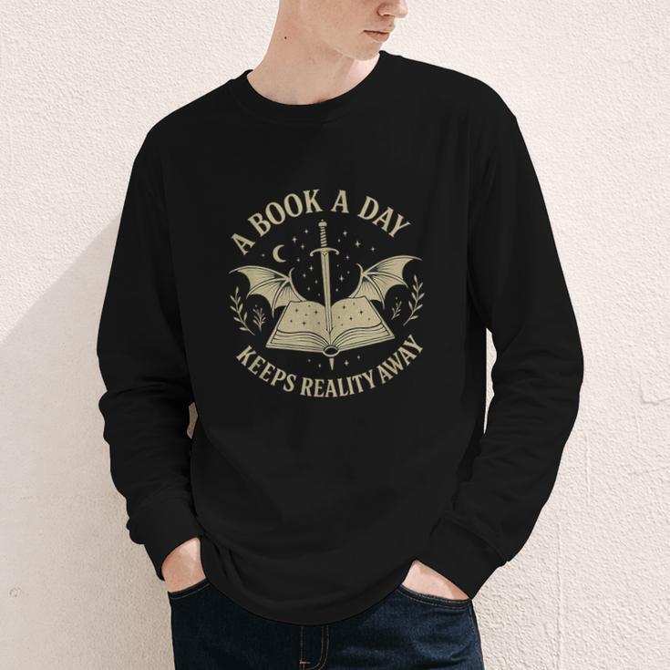 A Book A Day Keeps Reality Away Reading Escape Quote Youth Long Sleeve Tee A Book A Day Keeps Reality Away Reading Escape Quote Youth Long Sleeve Tee