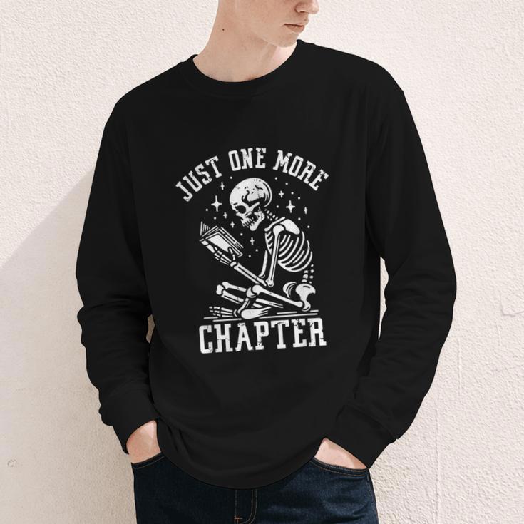 Just One More Chapter Skeleton Reading Book Youth Long Sleeve Tee Just One More Chapter Skeleton Reading Book Youth Long Sleeve Tee
