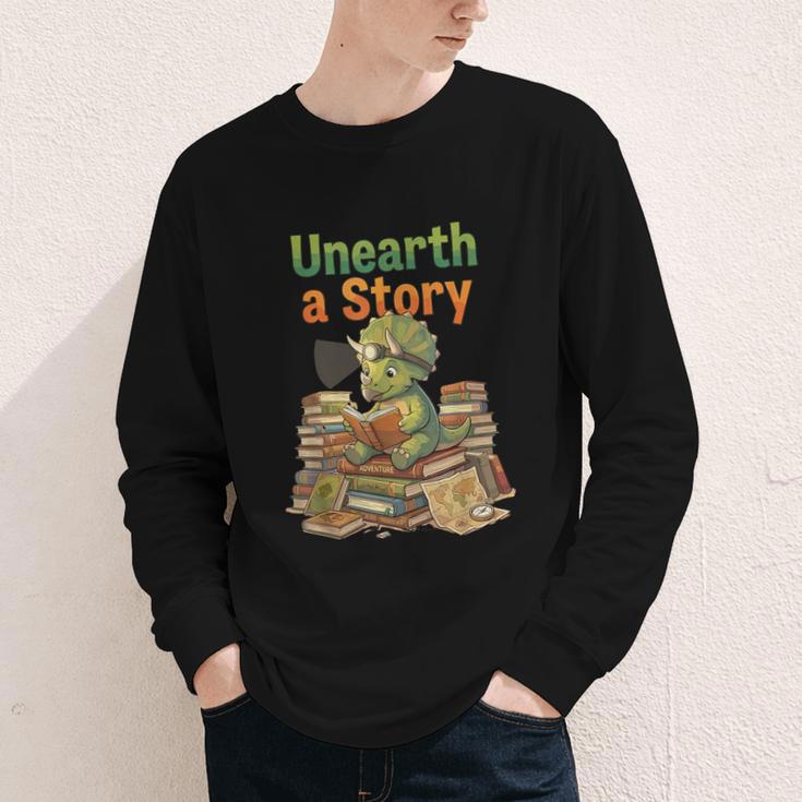 Unearth a Story Triceratops Dinosaur Reading Books Cute Dino Youth Long Sleeve Tee Unearth a Story Triceratops Dinosaur Reading Books Cute Dino Youth Long Sleeve Tee
