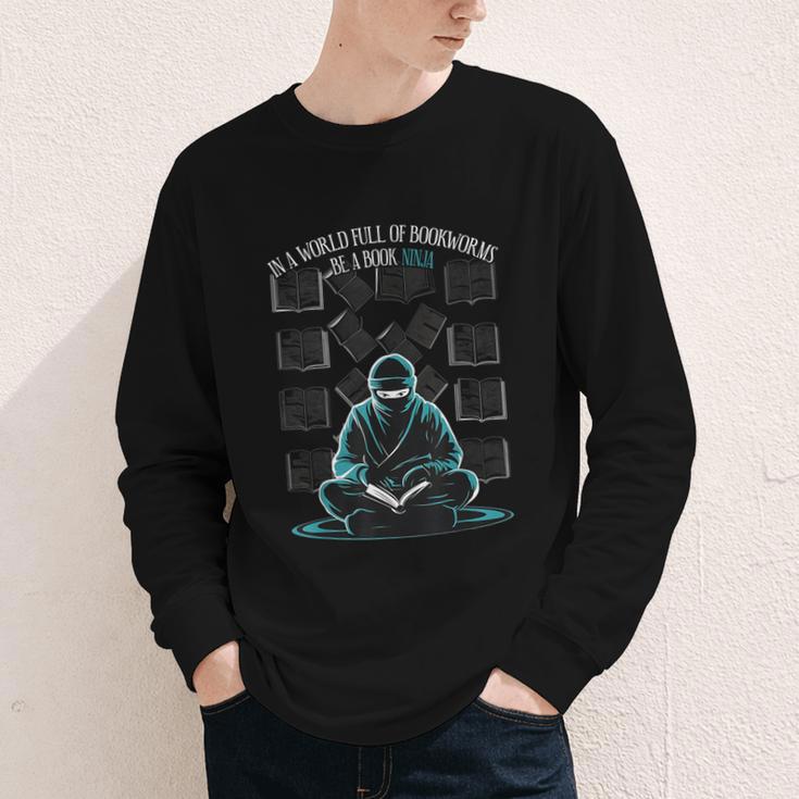 In A World Full Of Bookworms Be A Book Ninja Reading Reader Youth Long Sleeve Tee