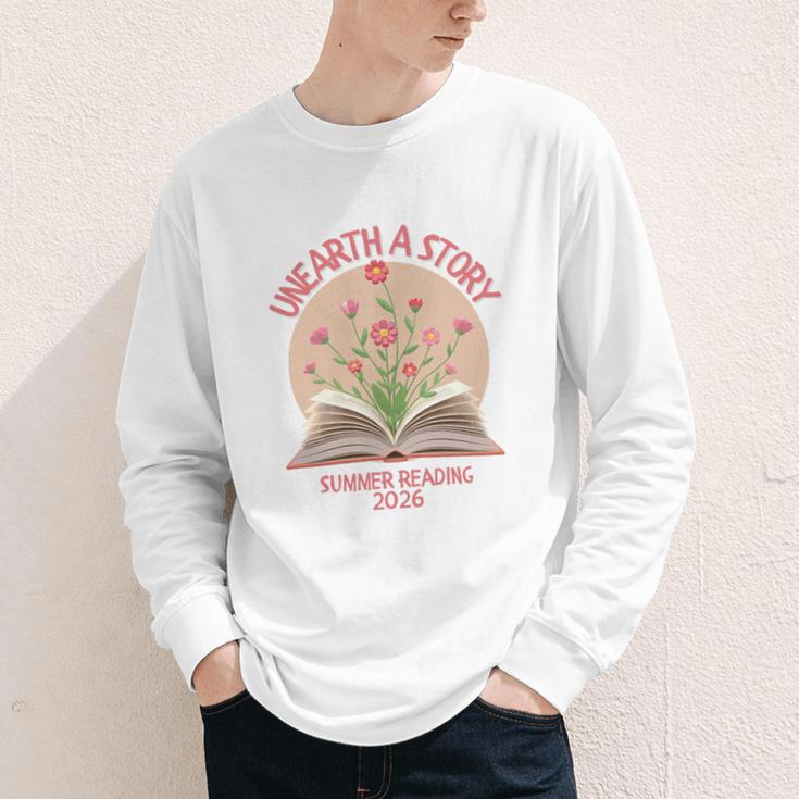 Unearth a Story 2026 Summer Reading Program Flowers Book Premium Tri-Blend Youth Long Sleeve Tee Unearth a Story 2026 Summer Reading Program Flowers Book Premium Tri-Blend Youth Long Sleeve Tee