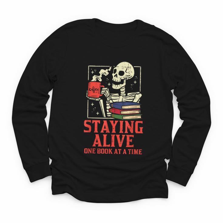 Staying Alive One Book At A Time Skeleton Reading Librarian Youth Long Sleeve Tee